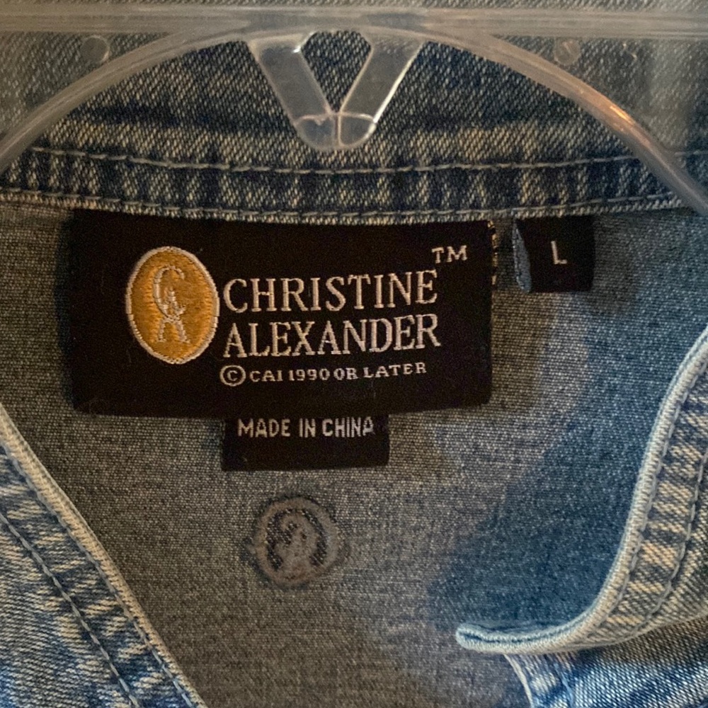 Denim jacket with diamond-like zipper. Has detailed seaming on back. Has pockets